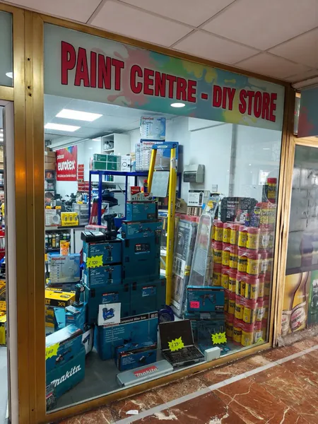&ldquo;Paint Centre – DIY Store&rdquo; in red vinyl lettering across the Splash Out shop window.
